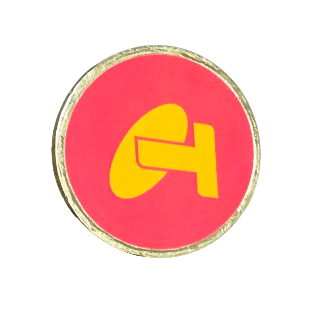 gold coin chocolate with pink label and a yellow logo